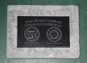 1812 Veteran Plaque mounted on retaining wall cap.
