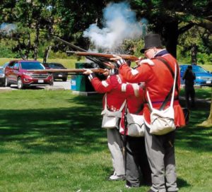 Re-enactors of 2nd Lincoln Militia firing off their muskets in honour of Private Levi Green.